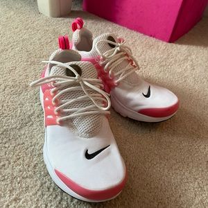 Women’s pink and white NIKE running shoes